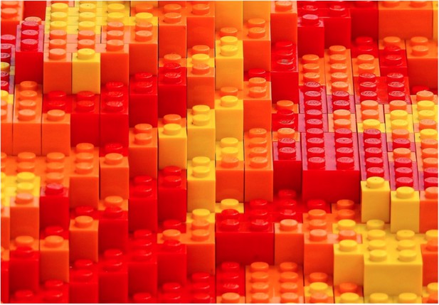 A structure composed of red, yellow and orange building blocks.