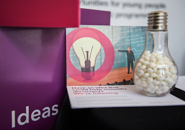 eLife postcard propped up again point of sale display saying Ideas, with lightbulb-shaped jar in foreground
